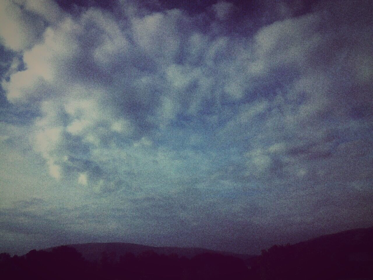 SCENIC VIEW OF MOUNTAINS AGAINST CLOUDY SKY