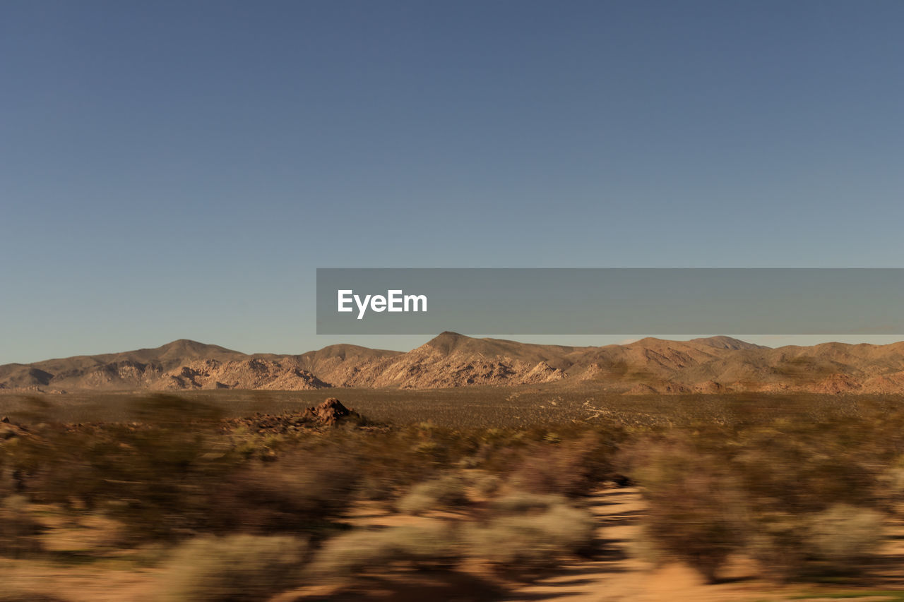 Scenic view of desert against clear sky