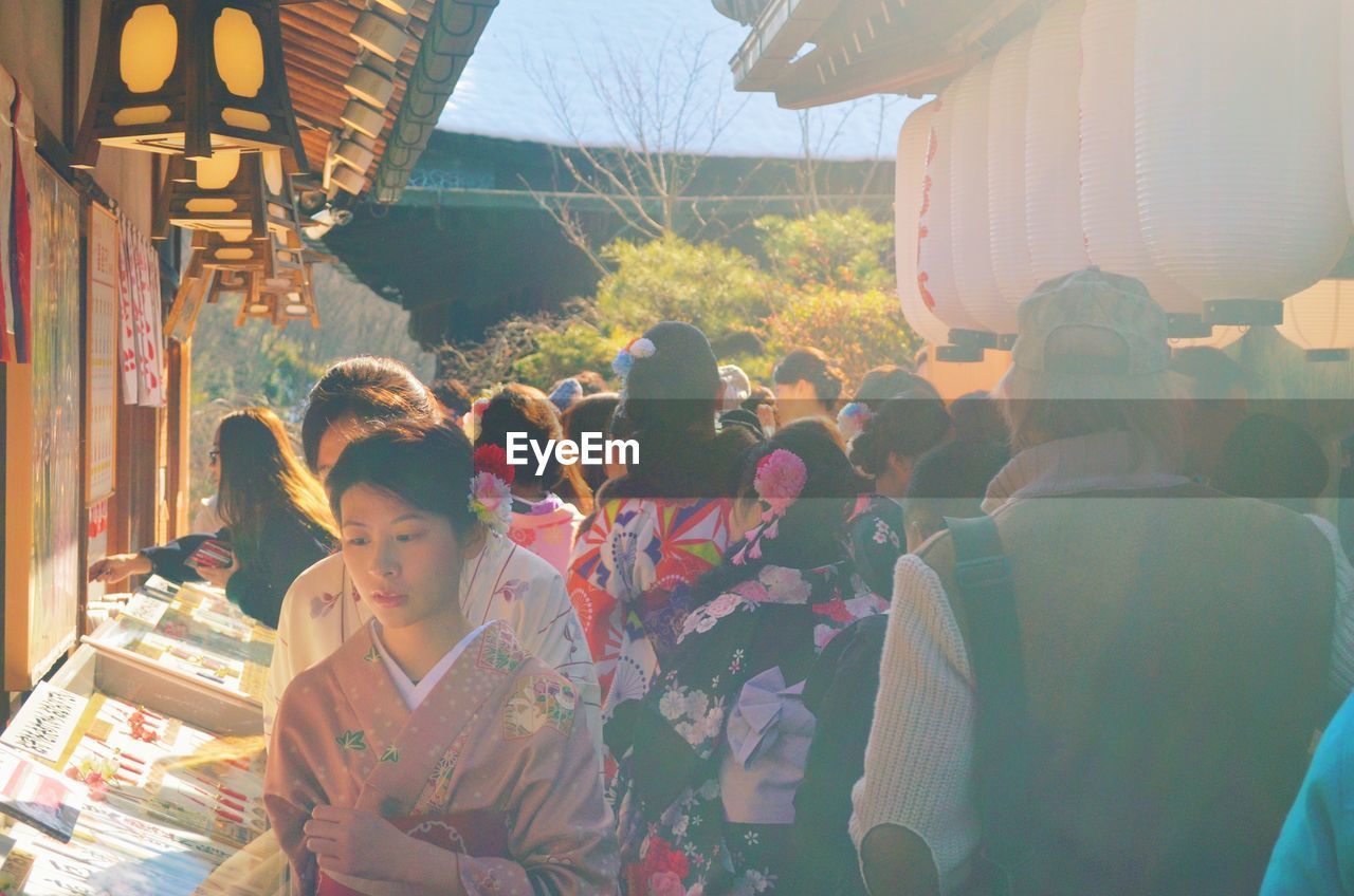 PEOPLE IN TRADITIONAL CLOTHING STANDING ON FLOWER