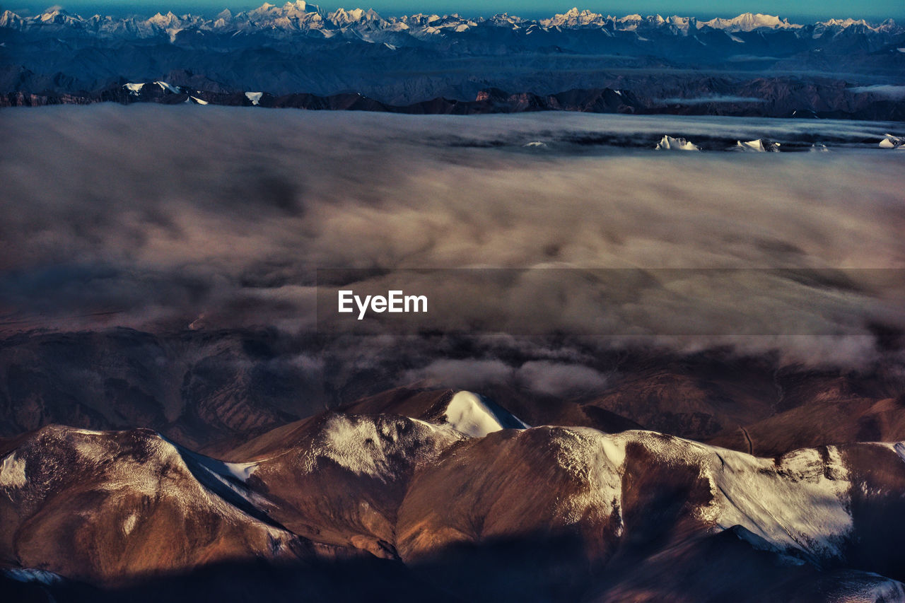 Aerial view of landscape with mountain range in background