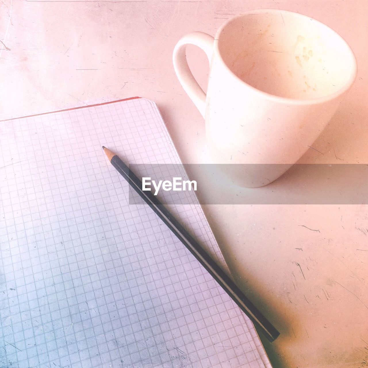 HIGH ANGLE VIEW OF PAPER AND TABLE ON TILED FLOOR