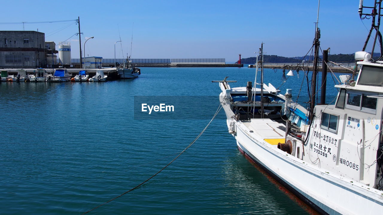 BOATS MOORED IN HARBOR