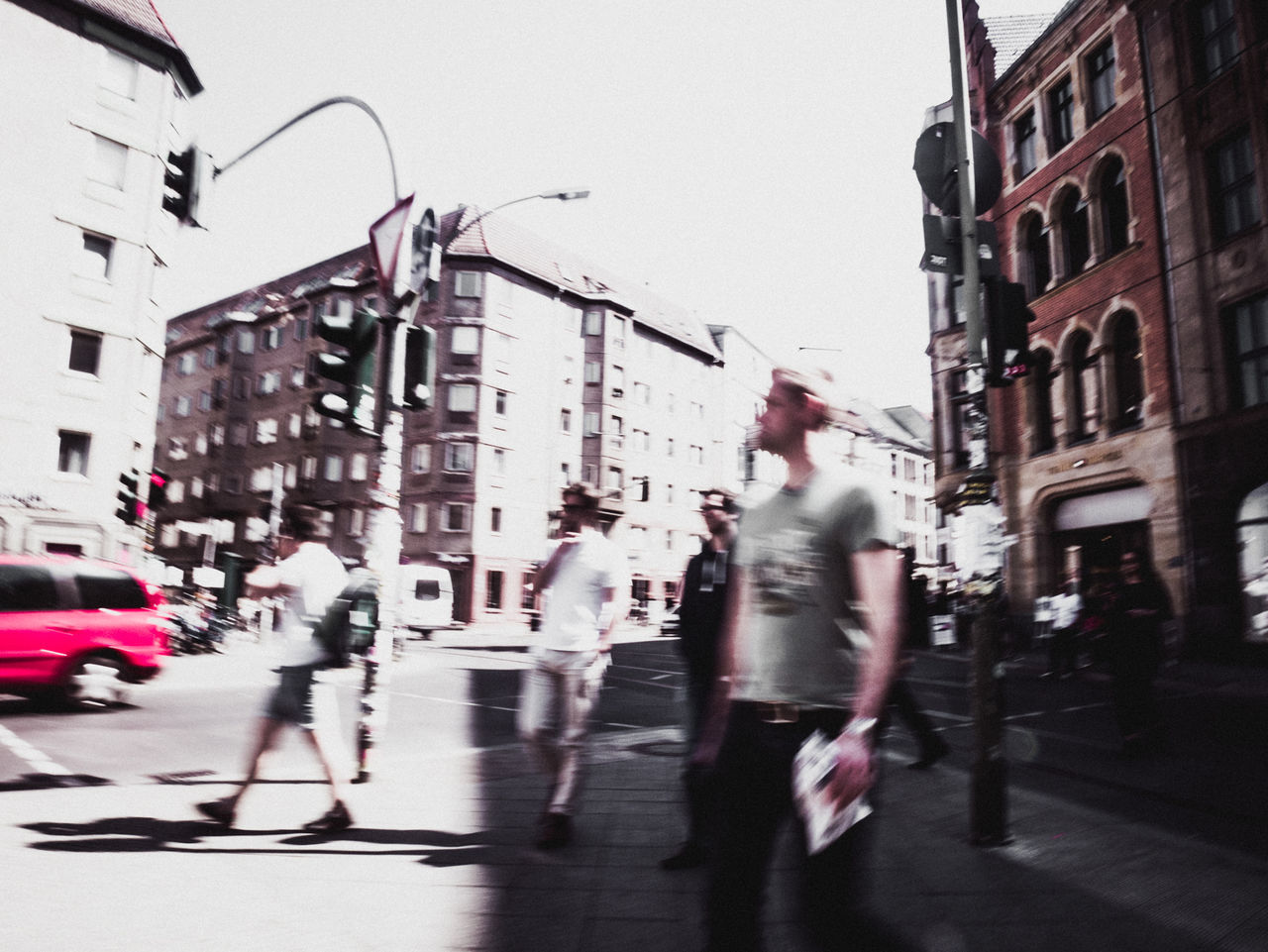 Men walking on sidewalk in city