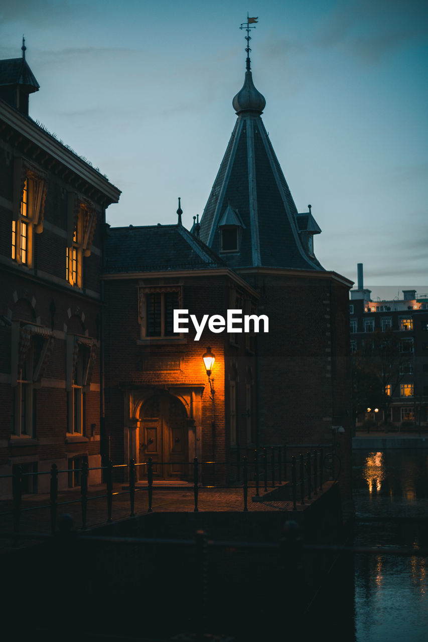 Illuminated buildings in city at dusk