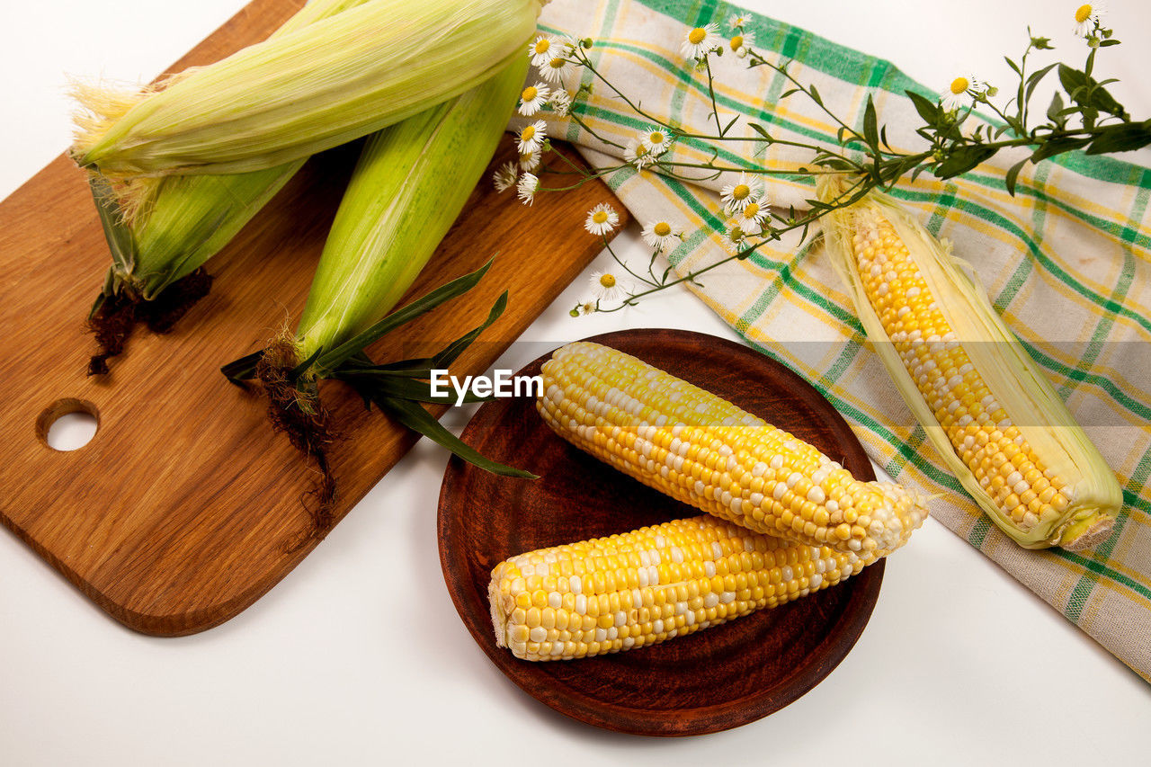 food, vegetable, food and drink, corn, corn kernels, healthy eating, sweet corn, produce, wellbeing, freshness, crop, cereal plant, dish, agriculture, plant, no people, yellow, food grain, still life, indoors, organic, nature, raw food, studio shot, high angle view