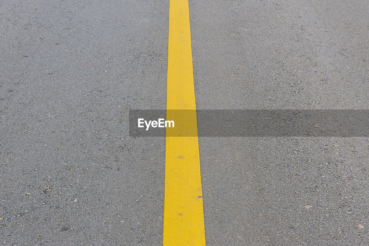 HIGH ANGLE VIEW OF YELLOW ROAD SIGN ON STREET