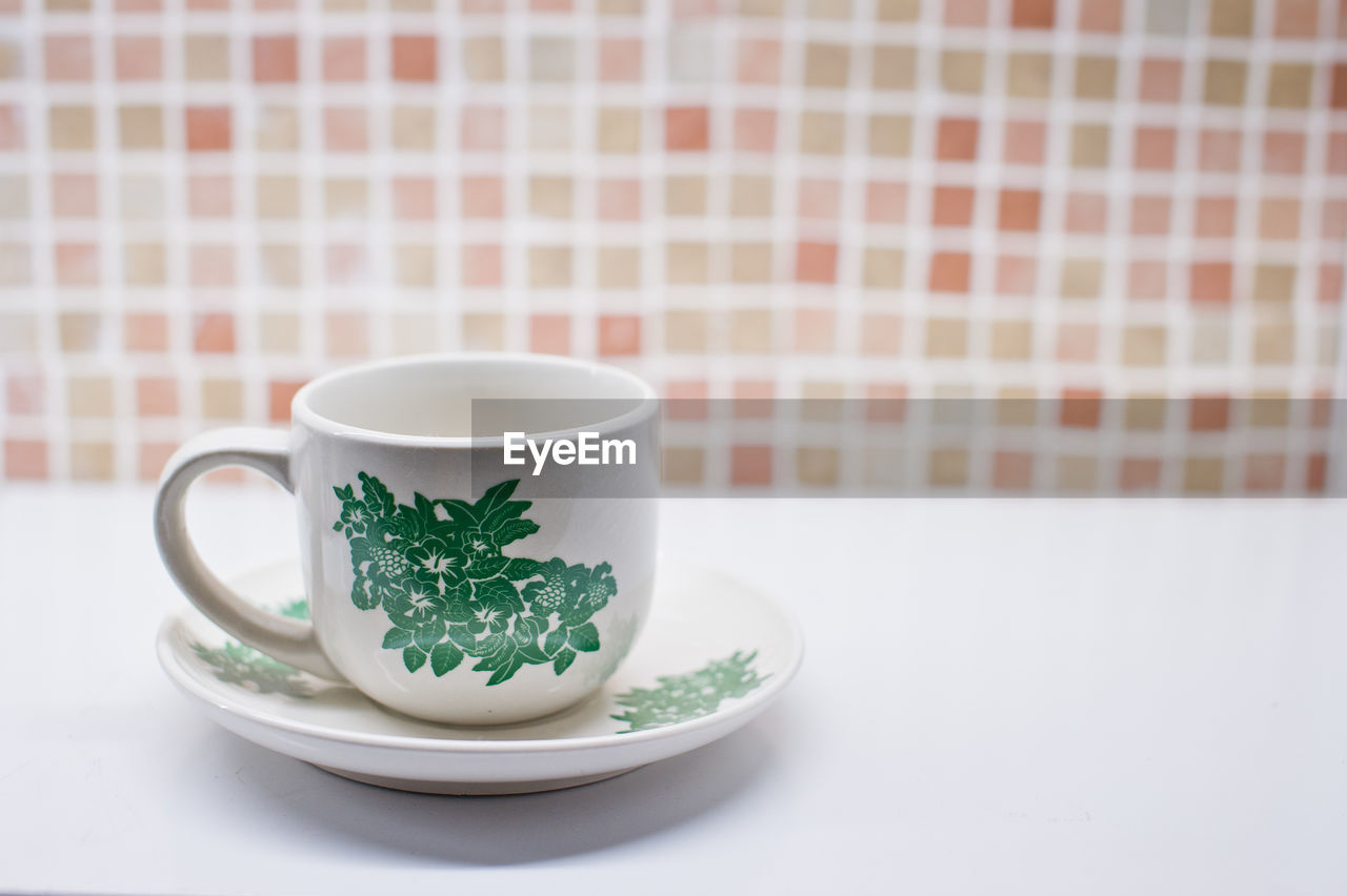 Close-up of cup and saucer on table