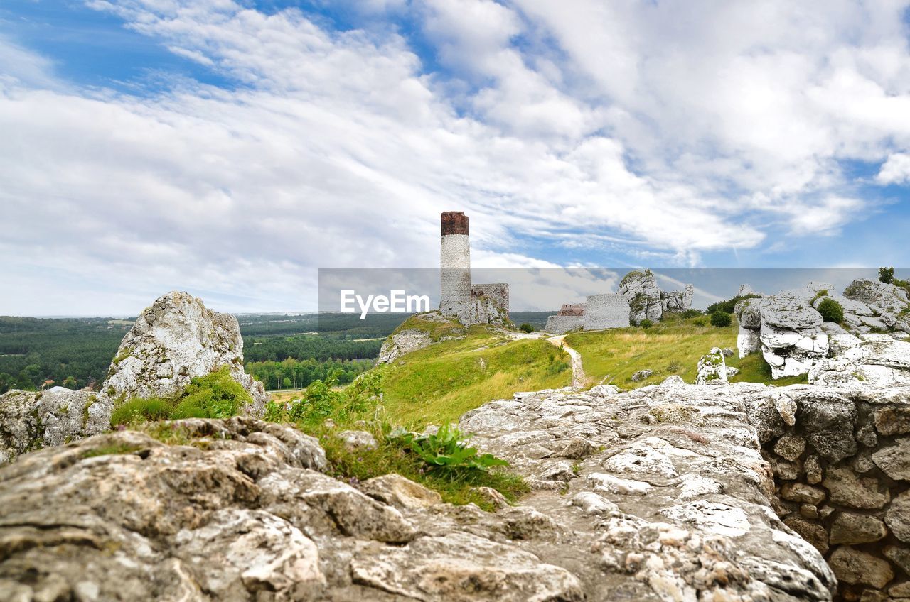 ROCK FORMATIONS AGAINST SKY WITH TREES IN FOREGROUND