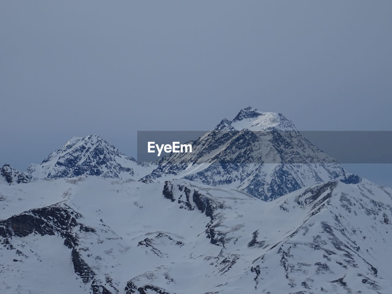 Scenic view of snowcapped mountains against clear sky