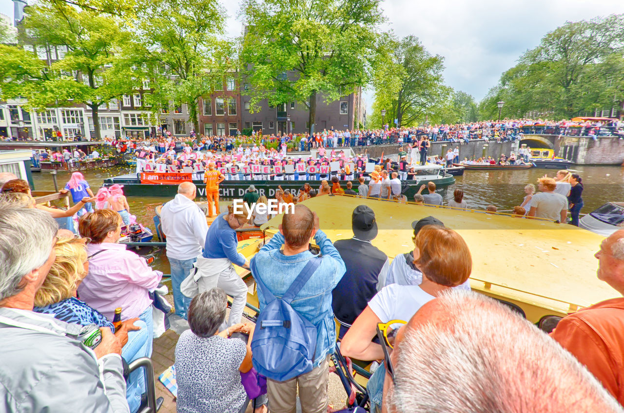 Crowd enjoying while at river during festival parade