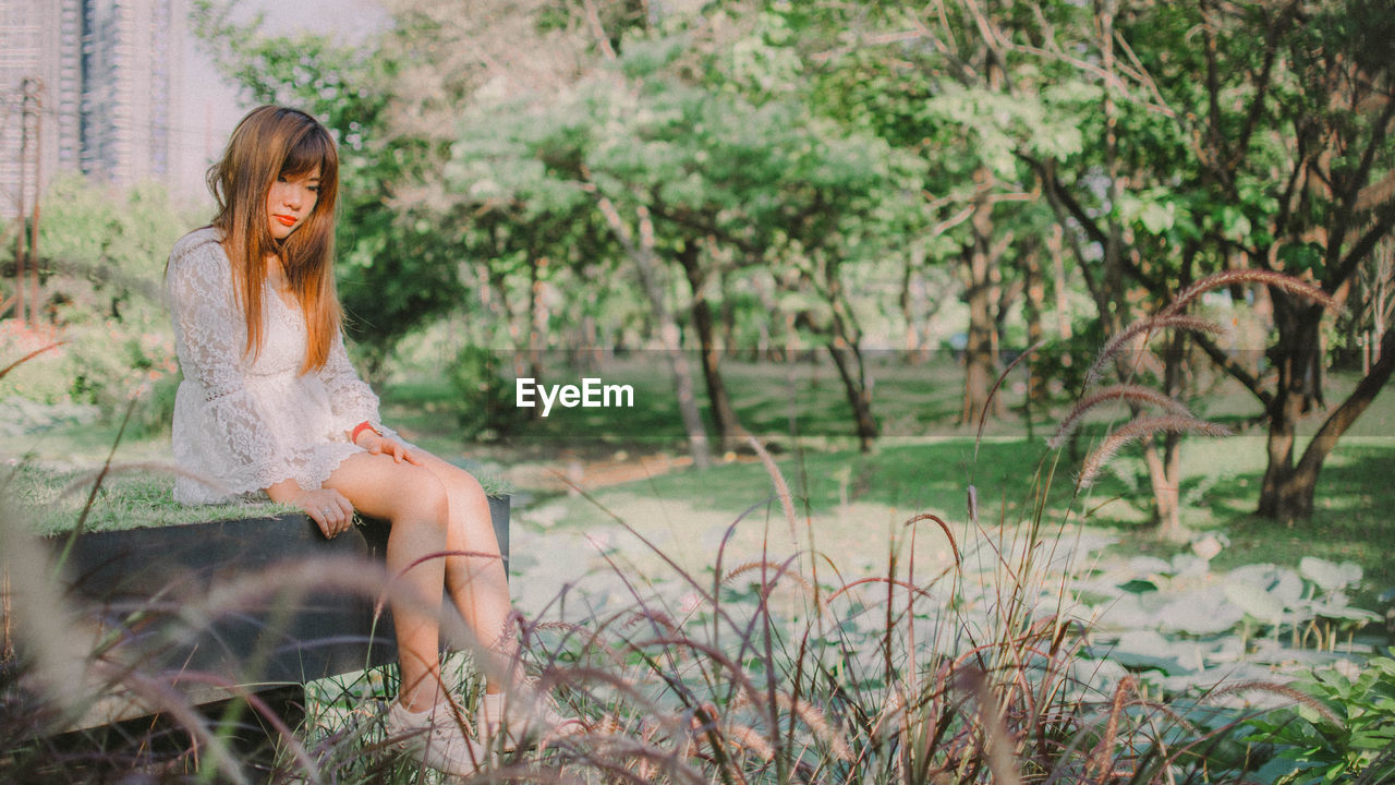 Full length of woman sitting in park