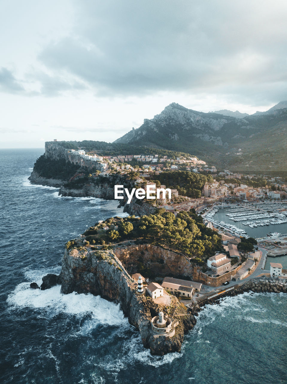 High angle view of sea and mountains against sky