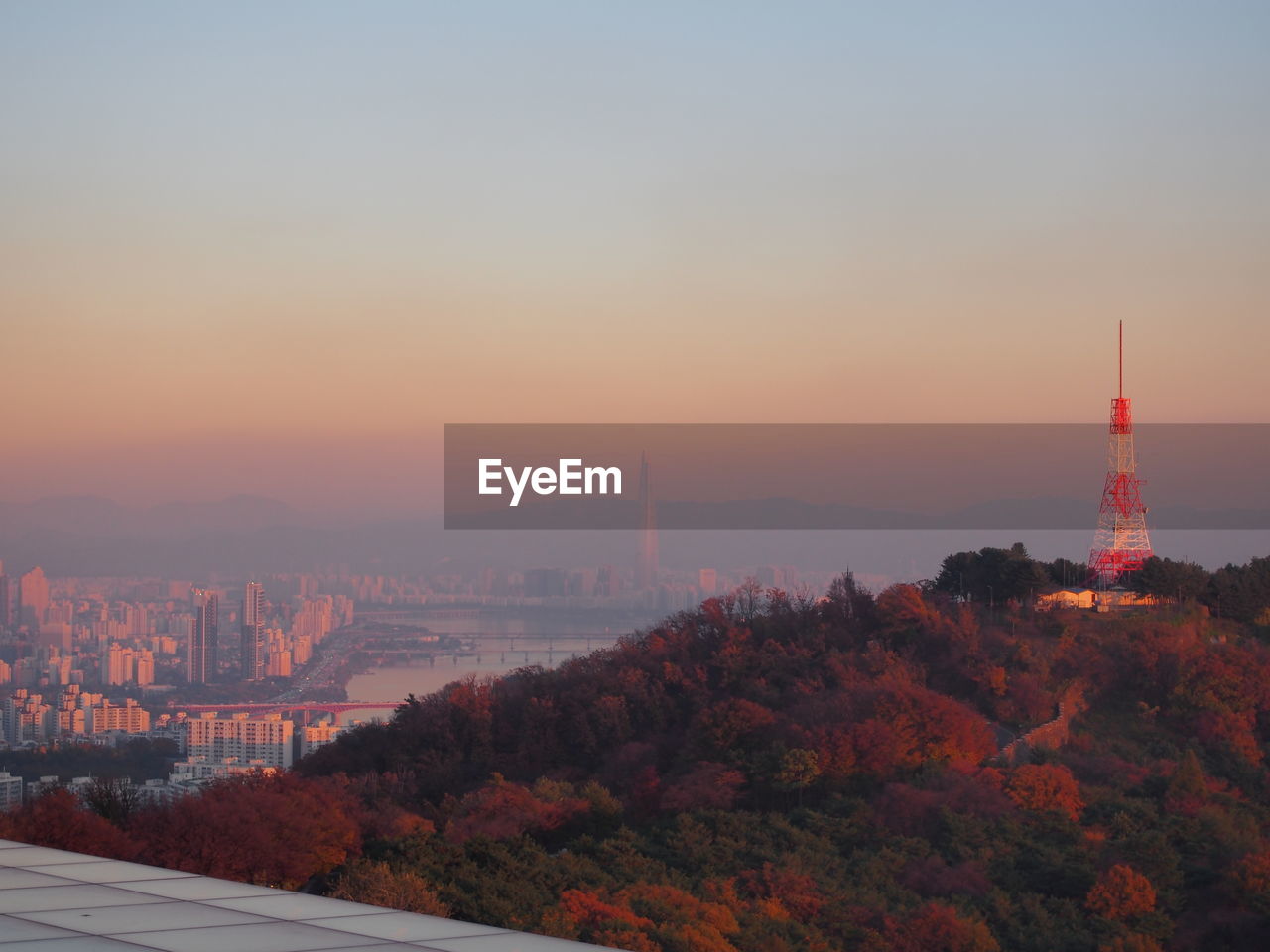 City buildings against sky during sunset