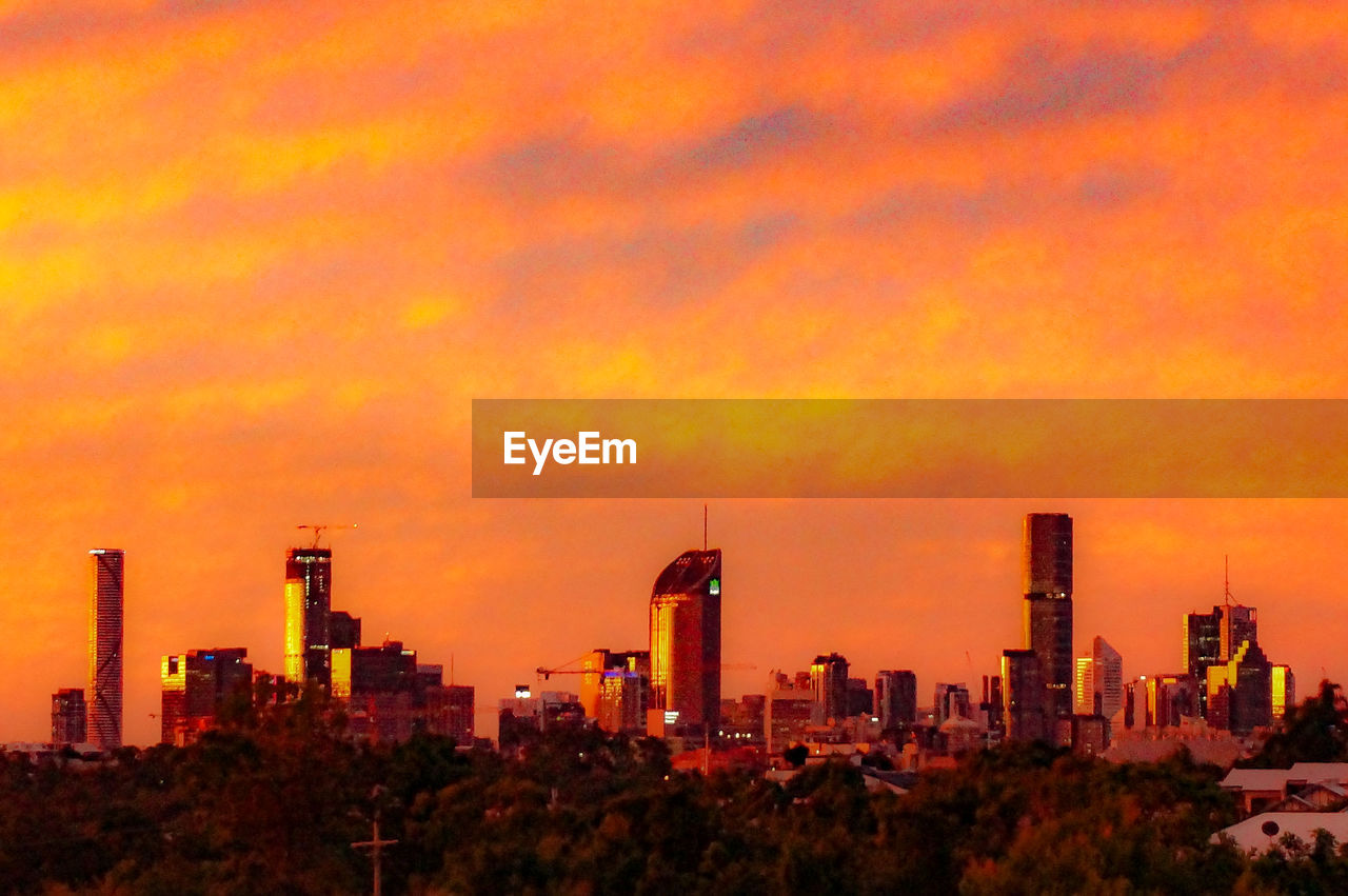 Vibrant orange sky over a downtown urban skyline on a cold may day.