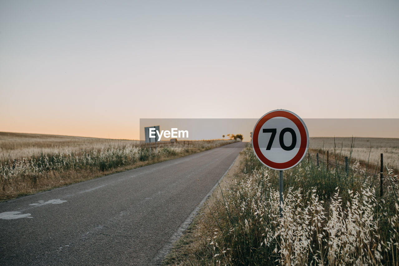 Road sign against clear sky