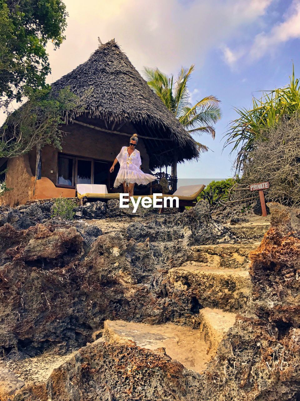 Woman standing against hut at resort