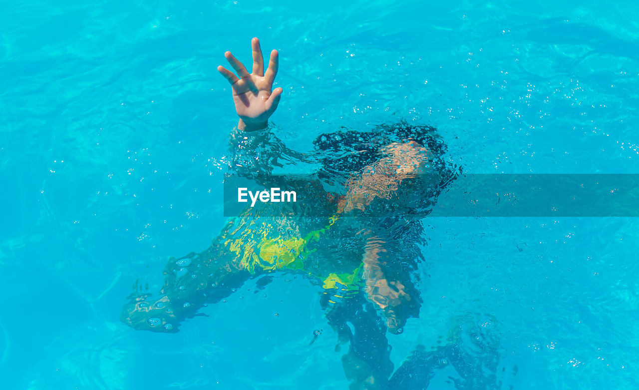 high angle view of woman swimming in sea