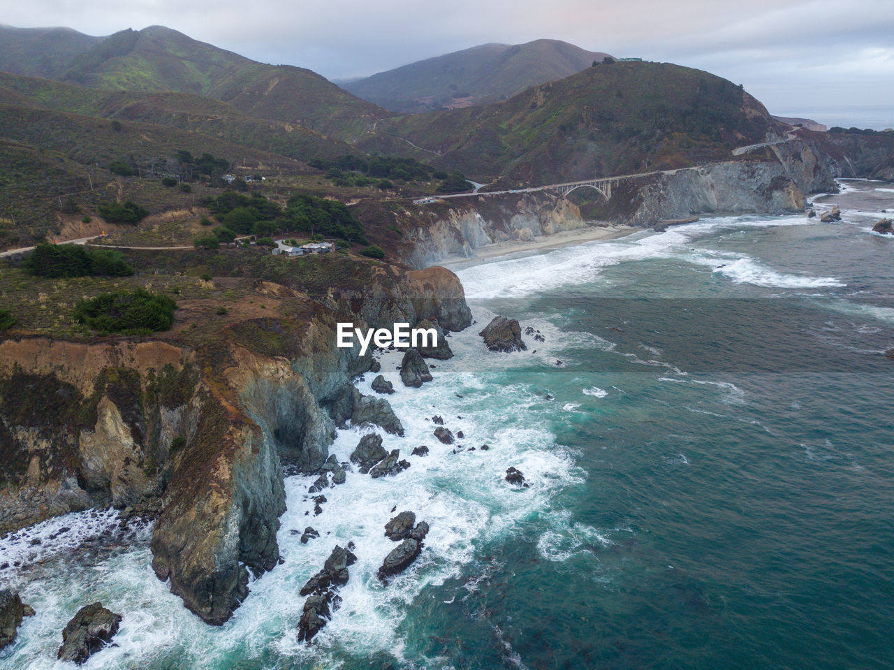 Scenic view of sea and mountains against sky