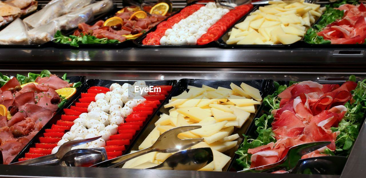 Tray filled with food and tomato mozzarella cheeses and vegetables