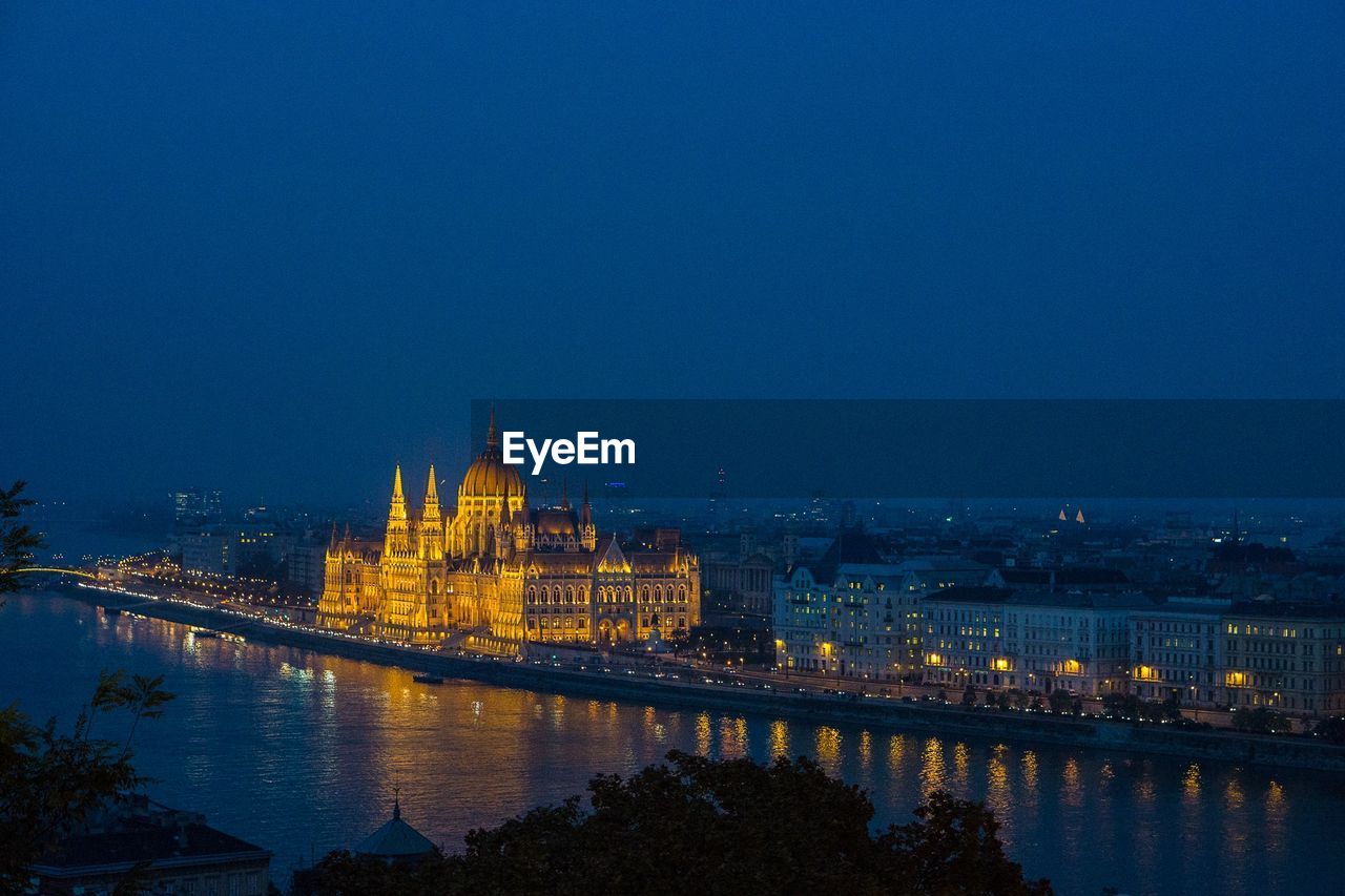 High angle view of illuminated city building against clear sky