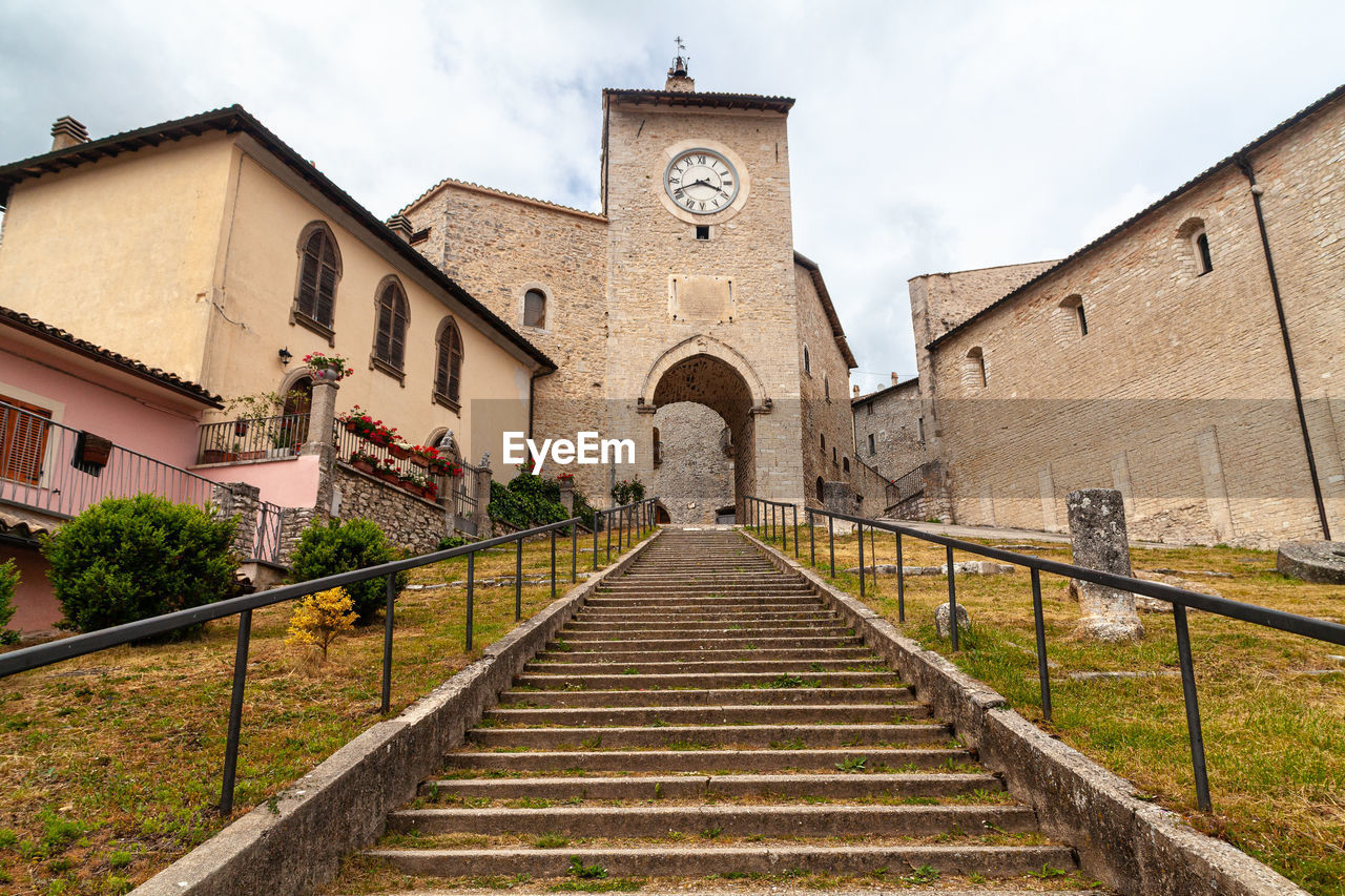 The tower with the clock at the top of the steps in monteleone di spoleto, umbria