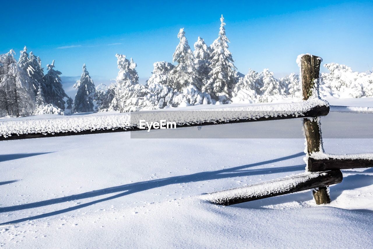 Snow covered field against sky