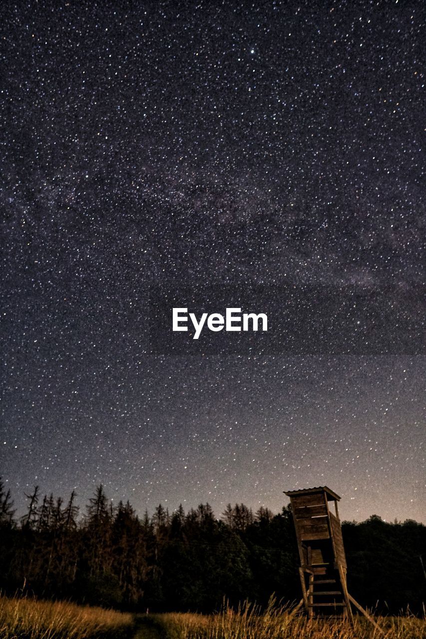 Scenic view of field against sky at night