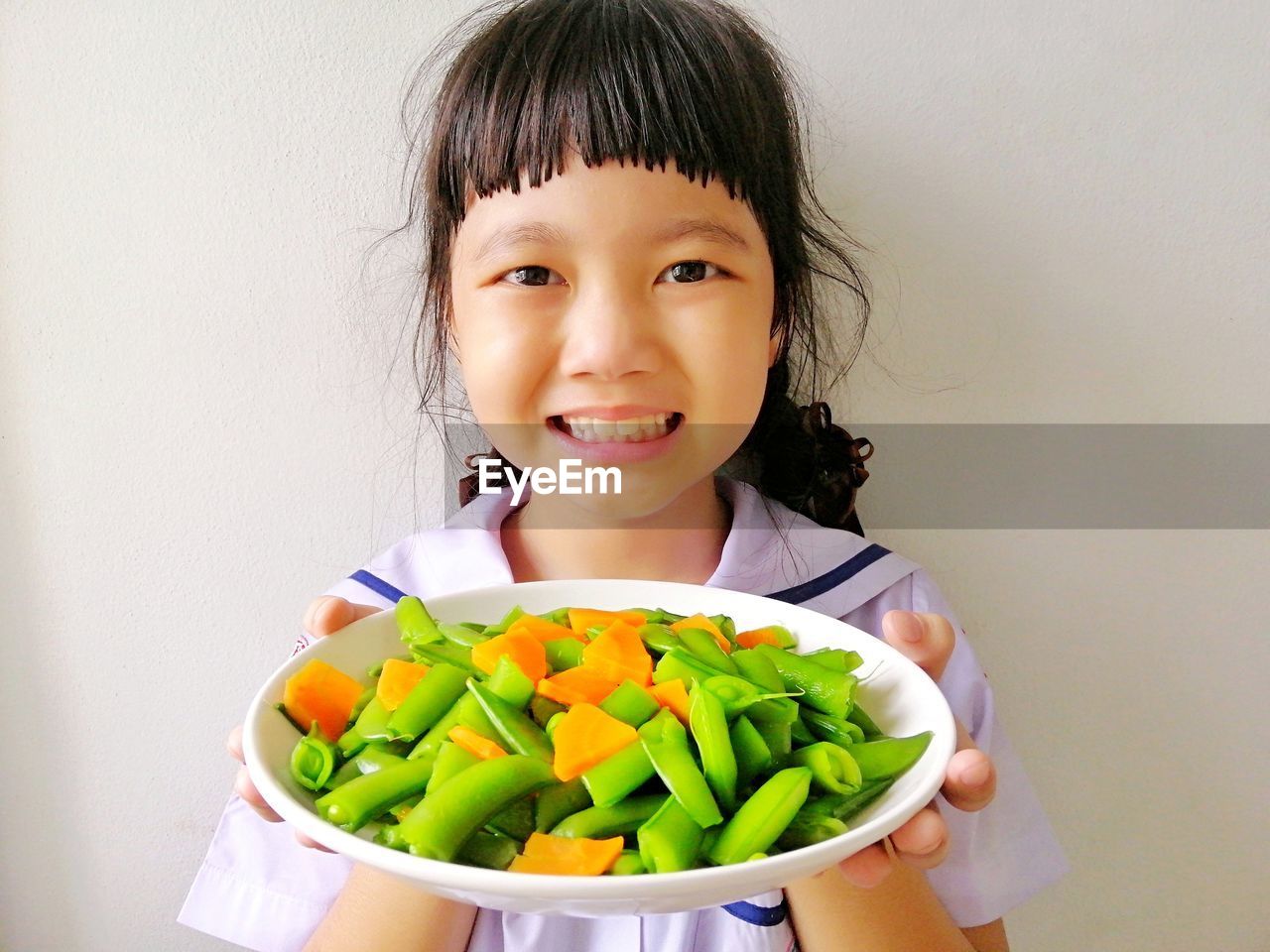 Portrait of smiling girl holding food