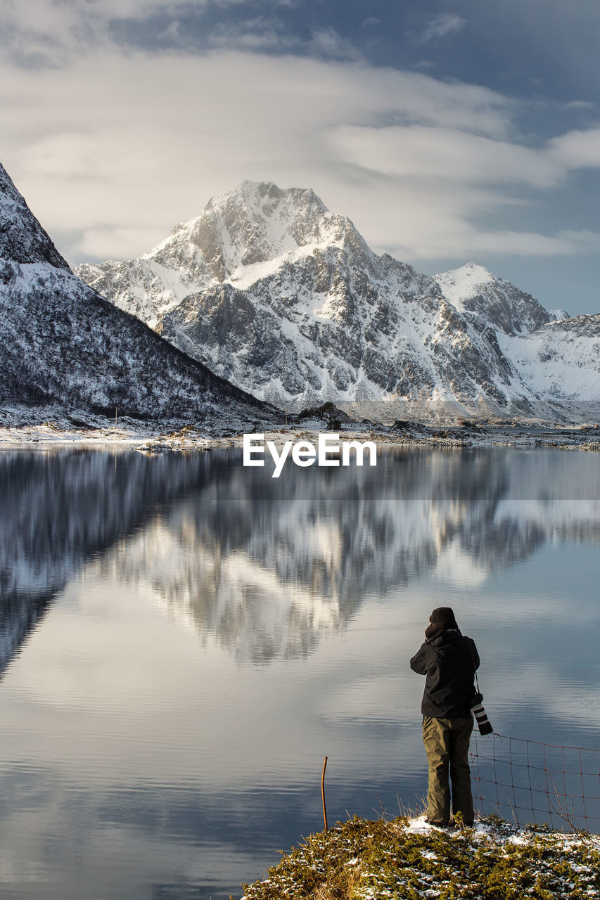 SCENIC VIEW OF LAKE AGAINST SNOWCAPPED MOUNTAINS