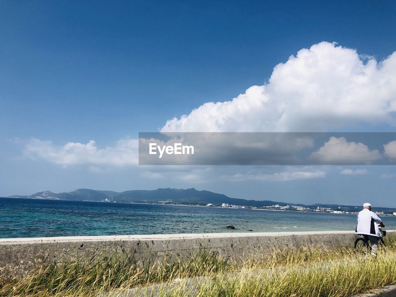 Rear view of sea against sky