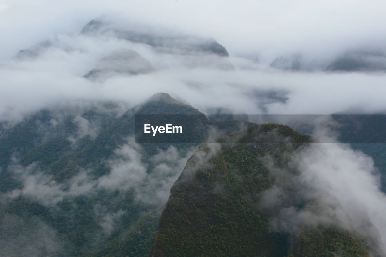 High angle view of fog on mountain against sky