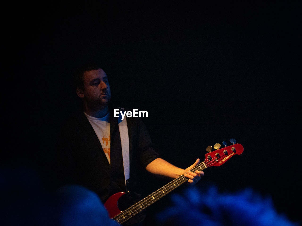 MAN PLAYING GUITAR AT MUSIC FESTIVAL