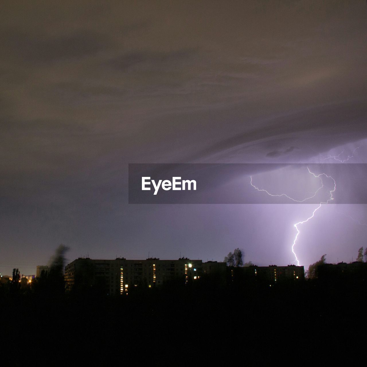 Lightning storm over city at night