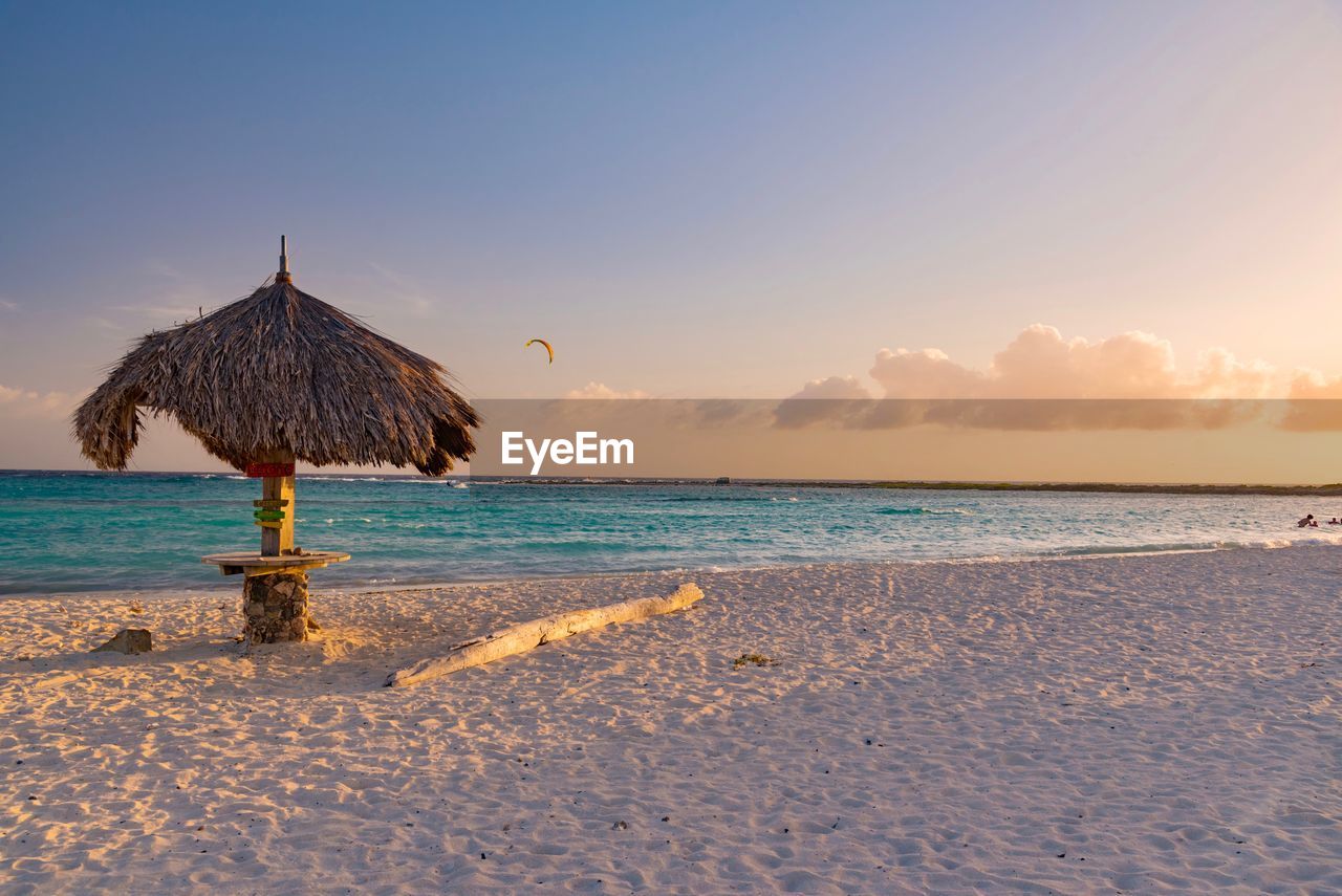 Scenic view of beach against sky during sunset