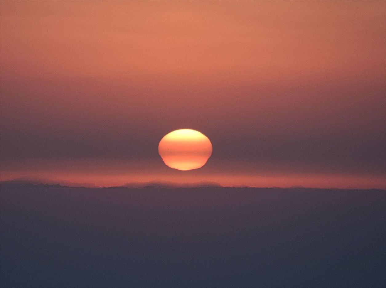 Idyllic shot of sun in orange sky during sunset