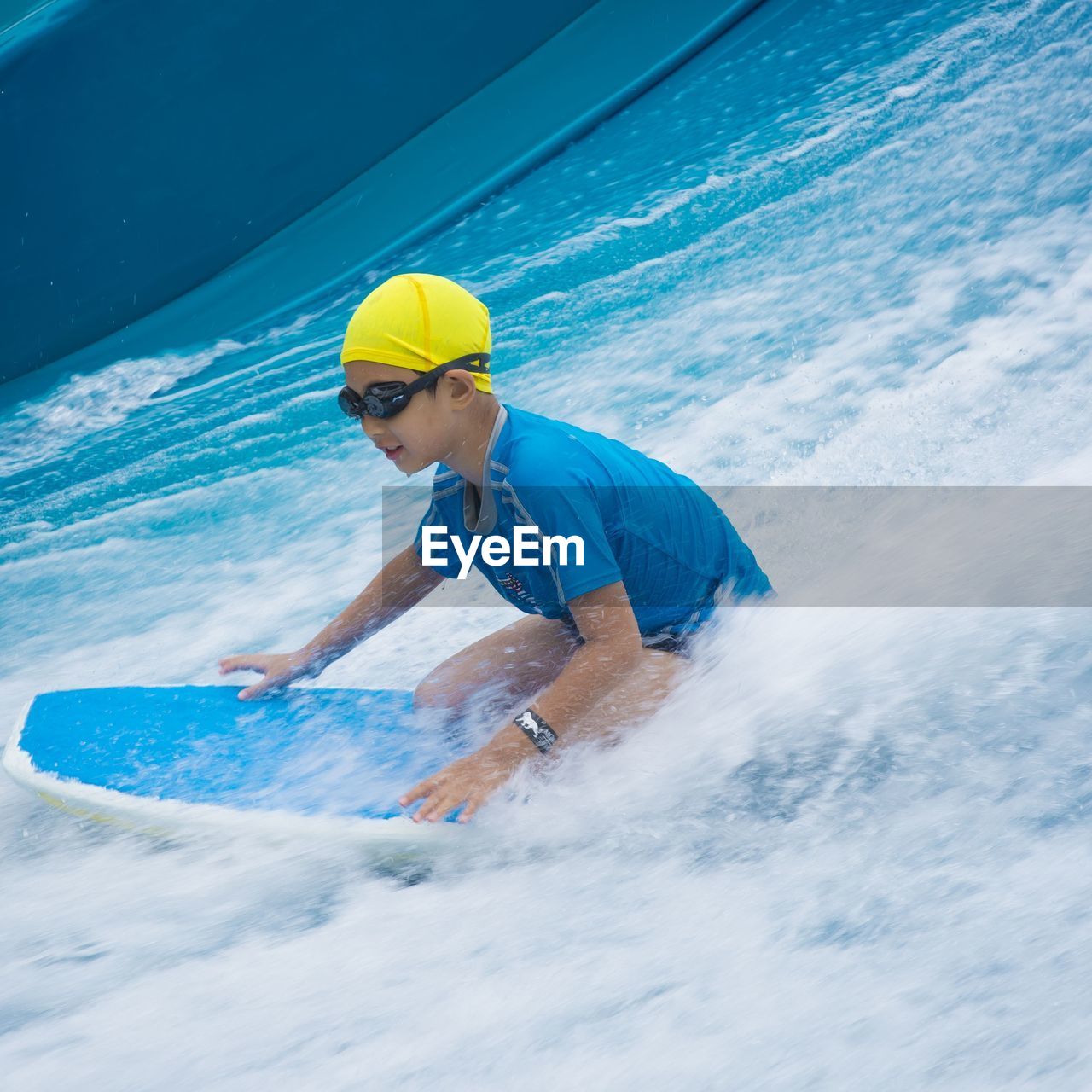 Boy surfing in sea