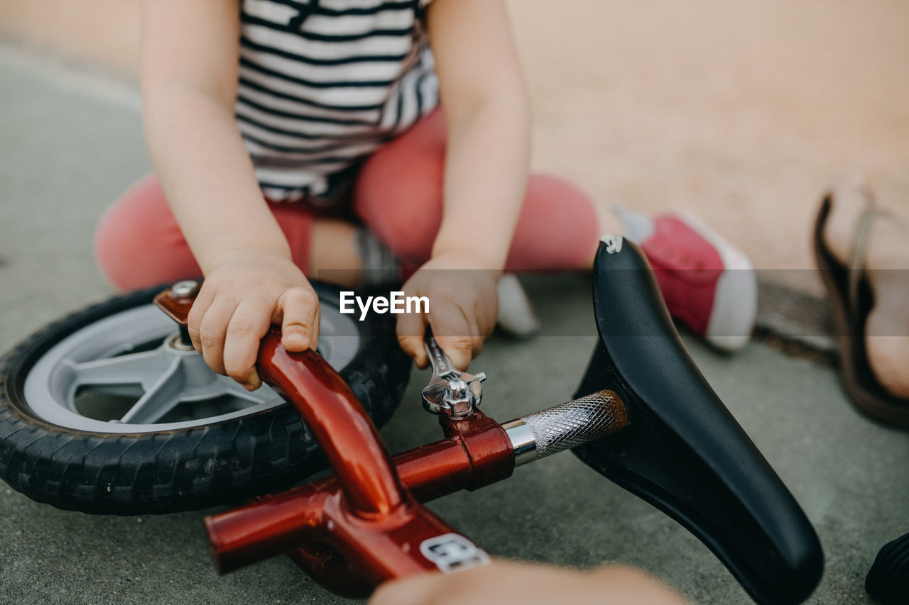 Mother and child fixing bike