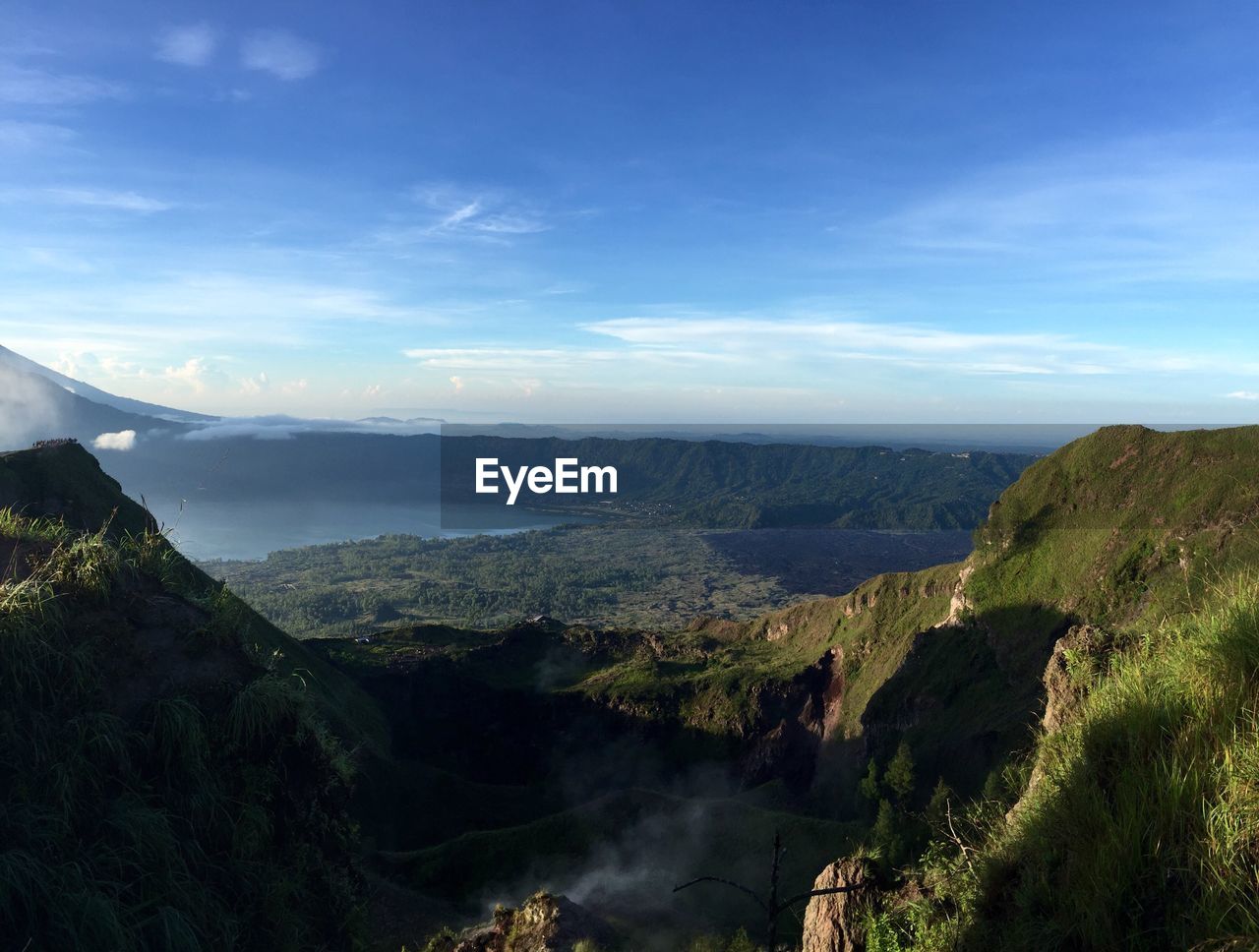 Scenic view of mountains against blue sky