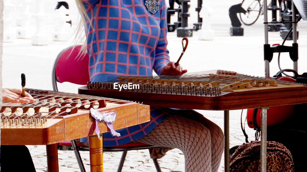 Midsection of woman playing string instrument