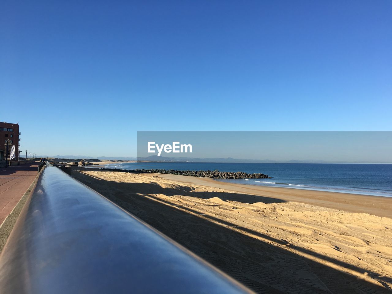 VIEW OF BEACH AGAINST BLUE SKY