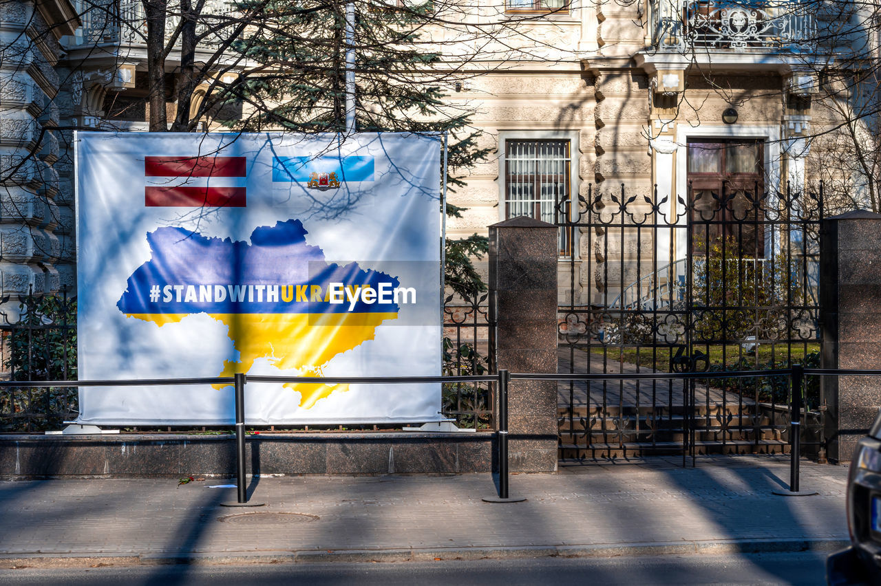 Riga, latvia, poster standwithukraine at the fence in front of the ukrainian embassy in riga, latvia