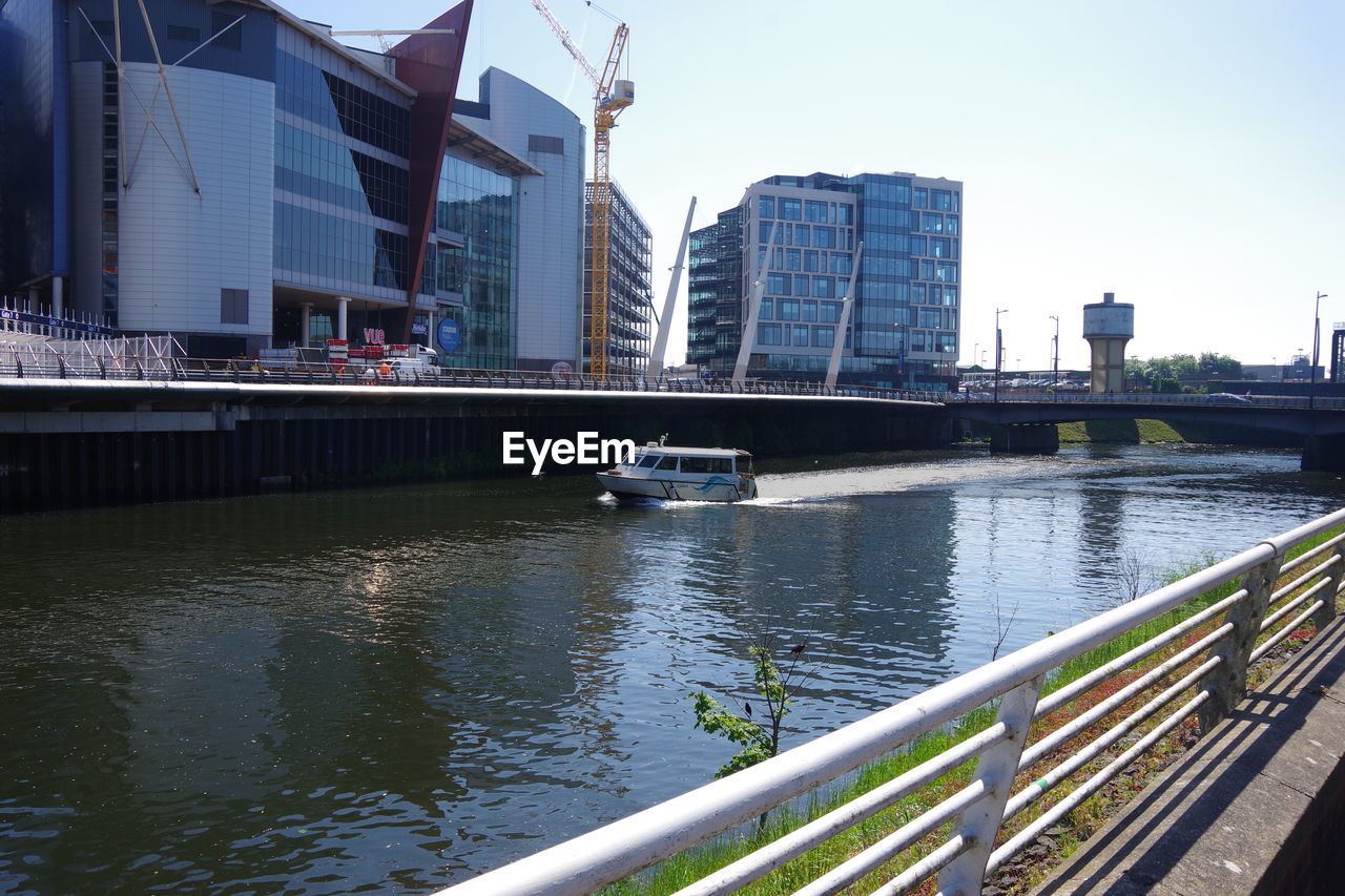 Boats in city against clear sky