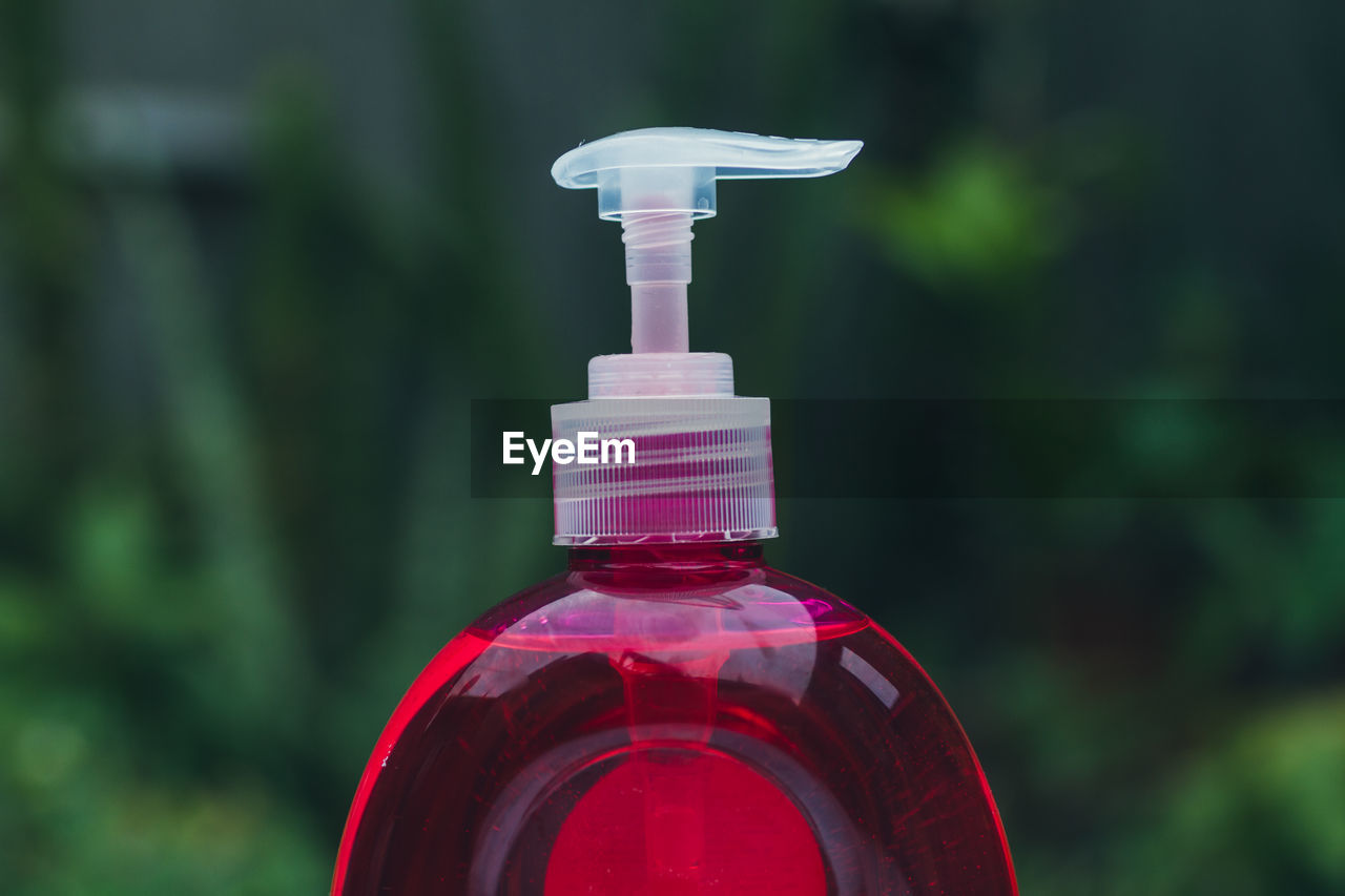 Pump bottle of red soap for cleaning and disinfecting hands