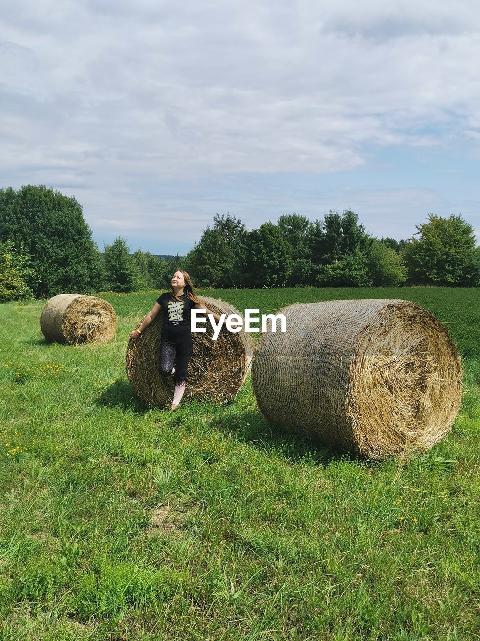 Hay bales on field against sky