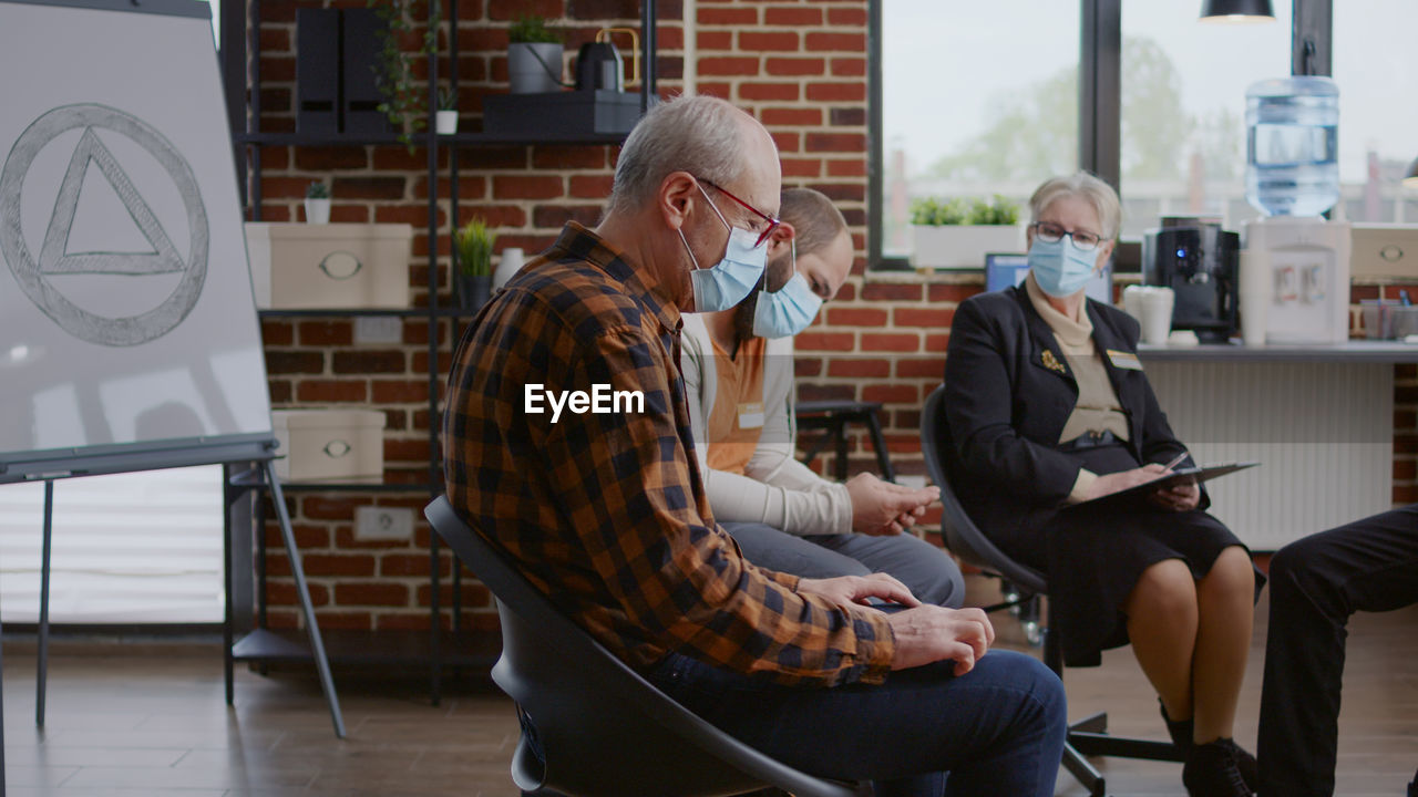 People wearing mask attending psychotherapy session