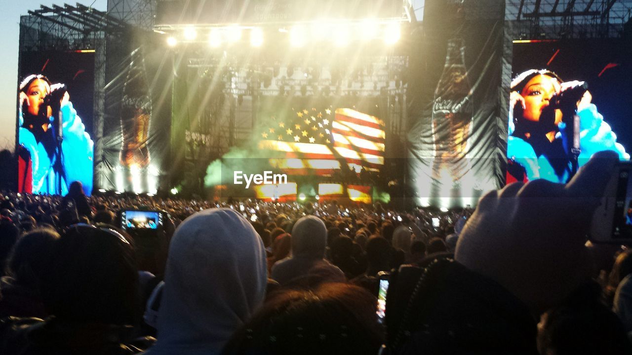 REAR VIEW OF PEOPLE WATCHING MUSIC CONCERT