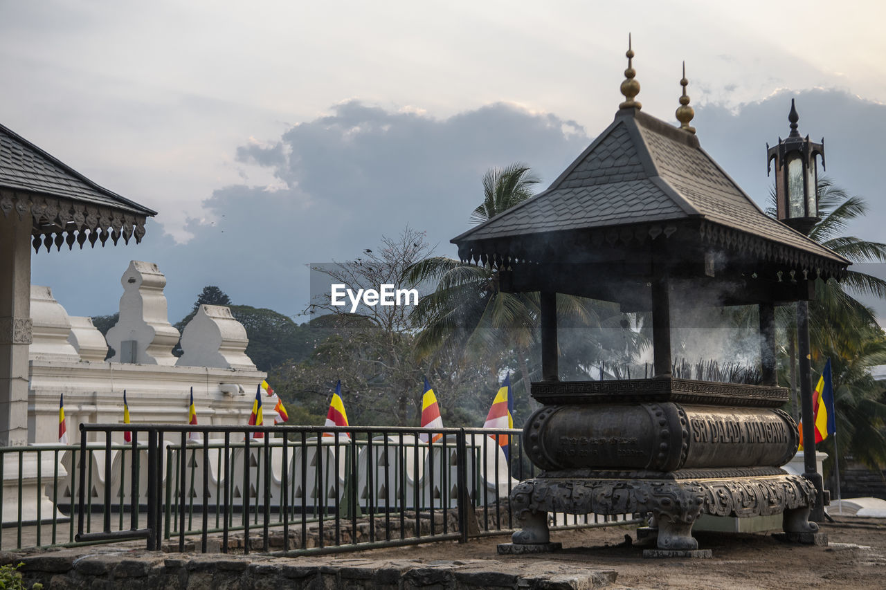 Burning incense at at the temple of the holy tooth relic in kandy