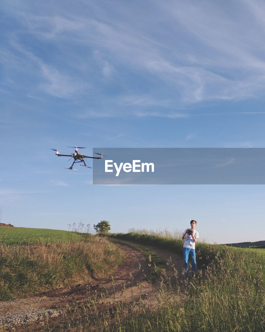 Man with drone on grassy field