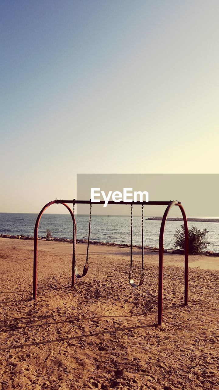 BICYCLE ON BEACH AGAINST CLEAR SKY