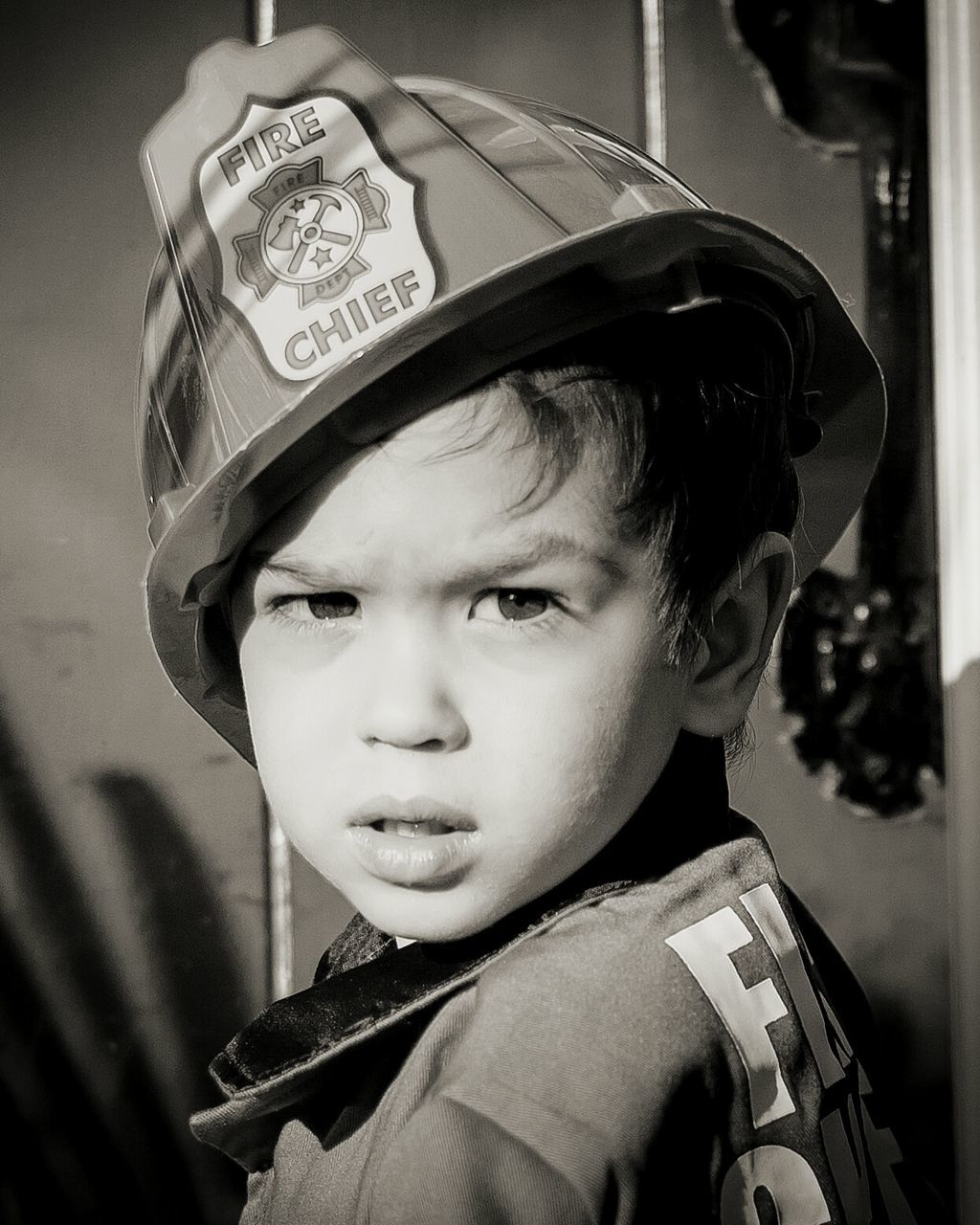 Portrait of boy in firefighter costume